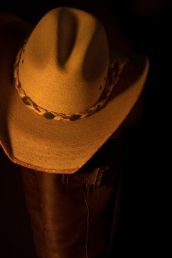 Still life photograph of cowboy hat and boots