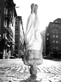 Black and white photograph of yogi doing a headstand in New York, by Michael O'Neill